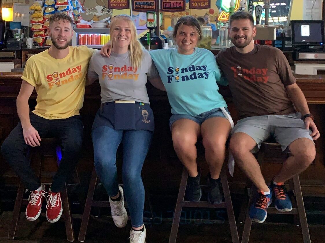 four frosty bar patrons wearing shirts from frosty's shop